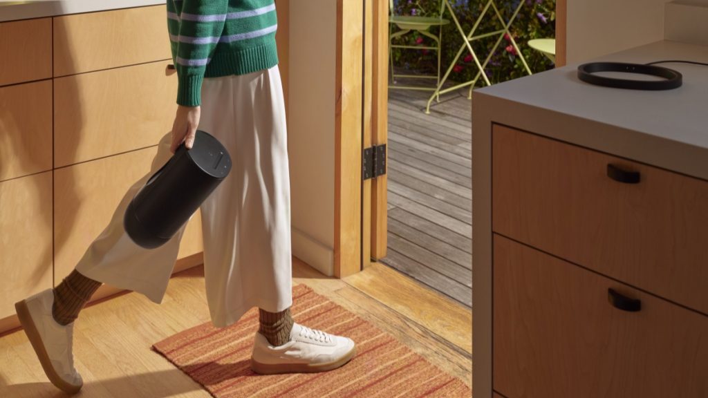 Sonos Move 2 being carried out the door by the carry handle