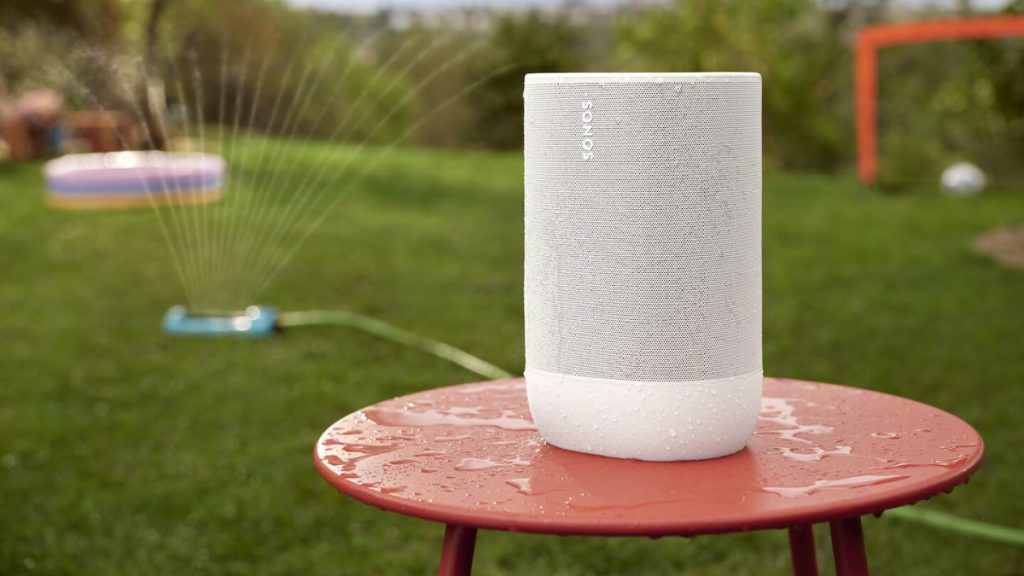 Sonos Move 2 on a table in the garden with water splashes on It