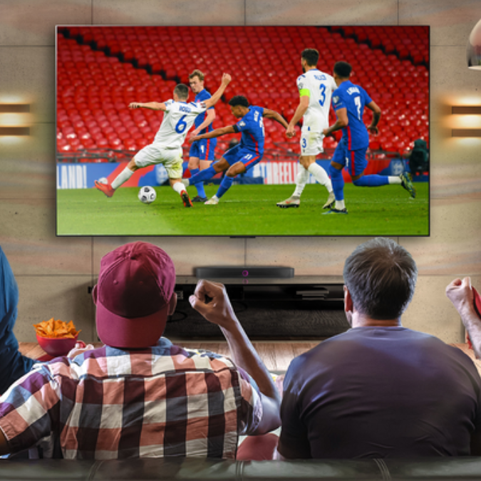 Group of people watching sports on TV